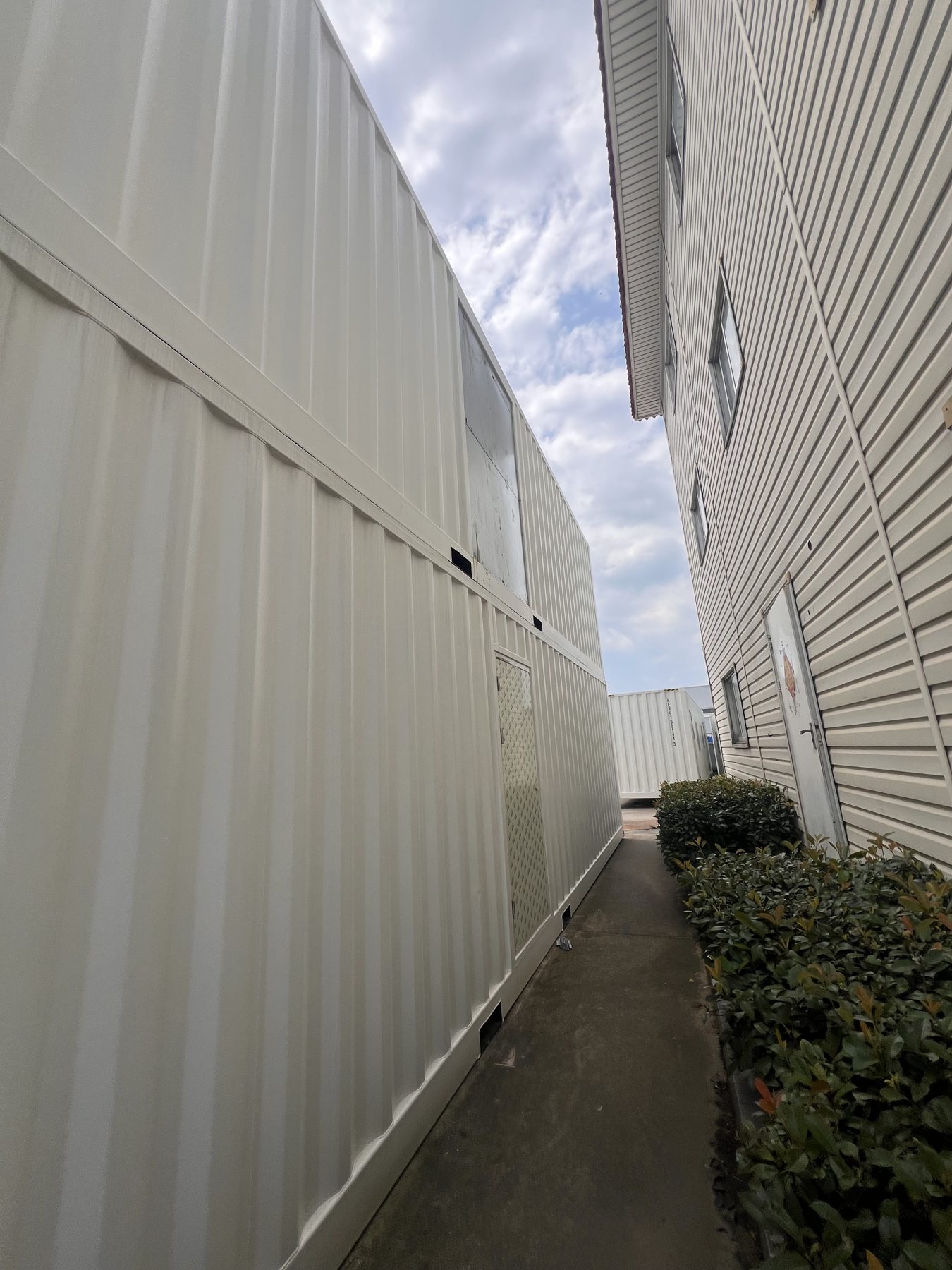 Corrugated exterior of a modular container structure